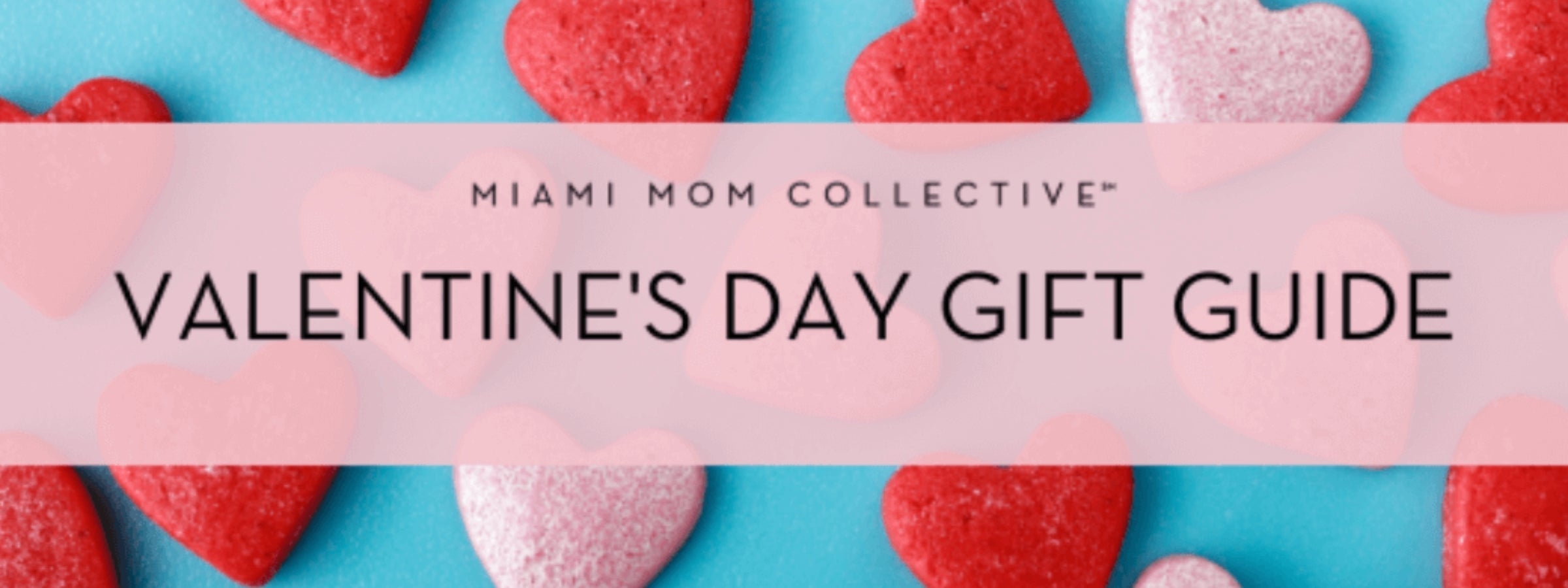 "Valentine’s Day Gift Guide" banner from Miami Mom Collective, featuring red and pink heart-shaped decorations on a bright blue background.